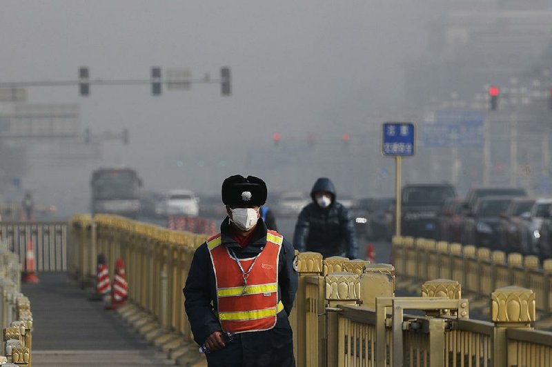A traffic officer wearing a mask patrols near Tiananmen Square in Beijing as smog blankets the Chinese capital in January. Antipollution efforts have helped improve air quality in Beijing. 