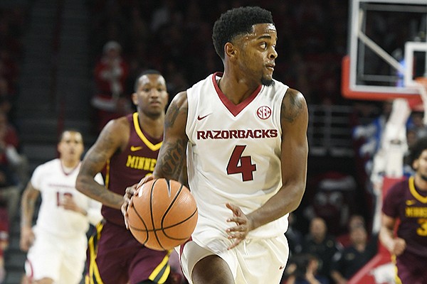 Arkansas guard Daryl Macon looks to pass the ball against Minnesota in the first half of an NCAA college basketball game Saturday, Dec. 9, 2017 in Fayetteville. (AP Photo/Michael Woods)

