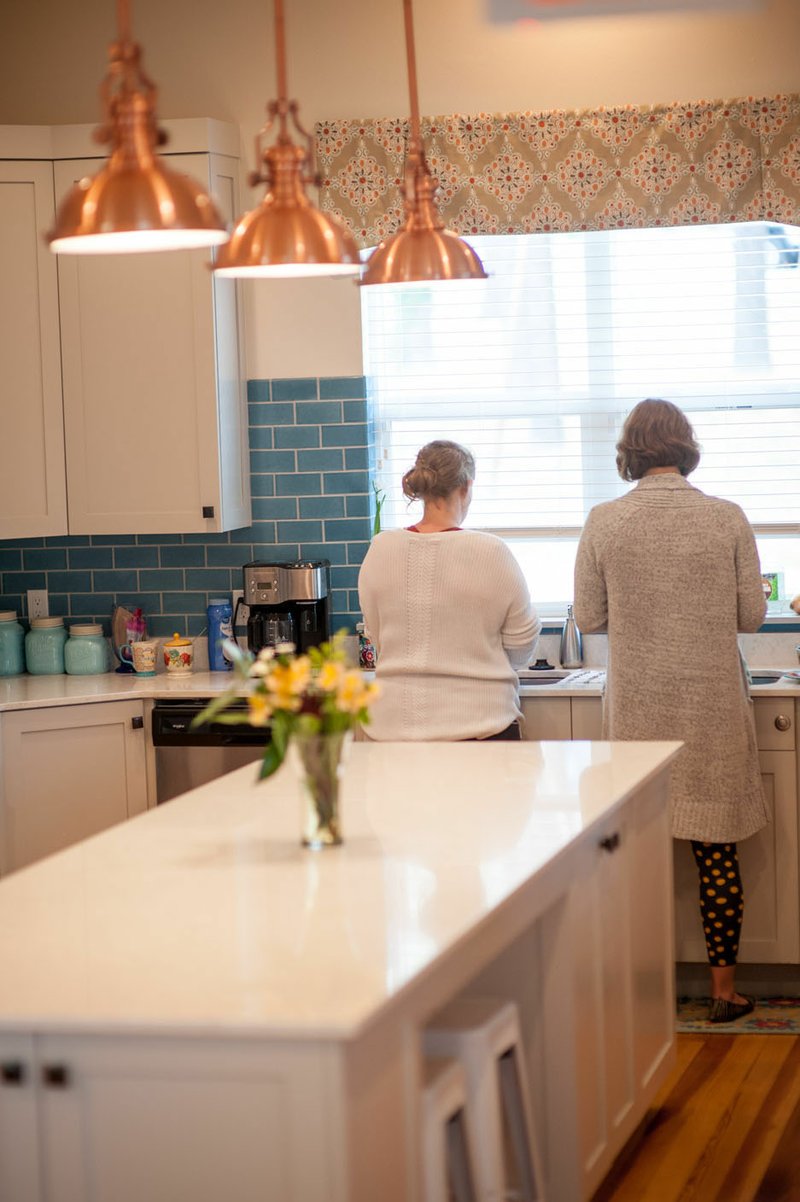 Residents of Magdalene House wash dishes in the modern farmhouse-style kitchen. The mission of St. Paul’s Episcopal Church in Fayetteville, Magdalene House is a sanctuary for women who have experienced sexual trauma, exploitation, trafficking and substance abuse addiction. Residents share bedroom spaces, but the house is designed with multiple private nooks that allow for personal reflection and meditation.

