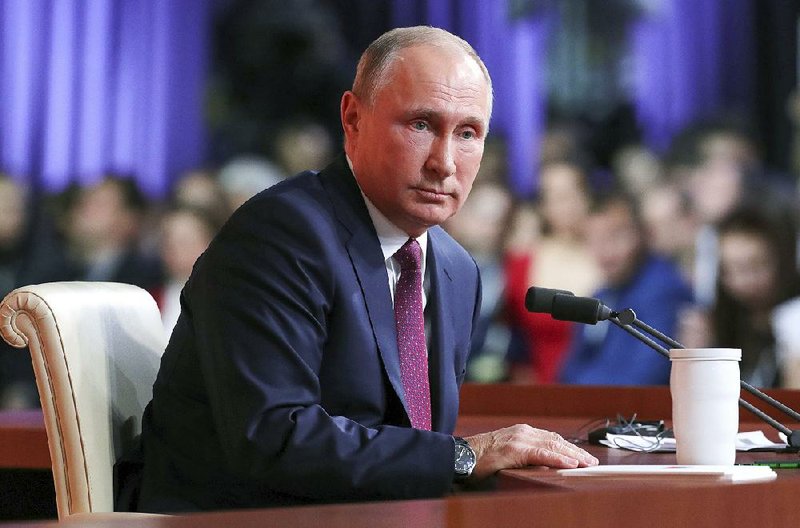 Russian President Vladimir Putin listens to a question during his four-hour annual news conference Thursday in Moscow.