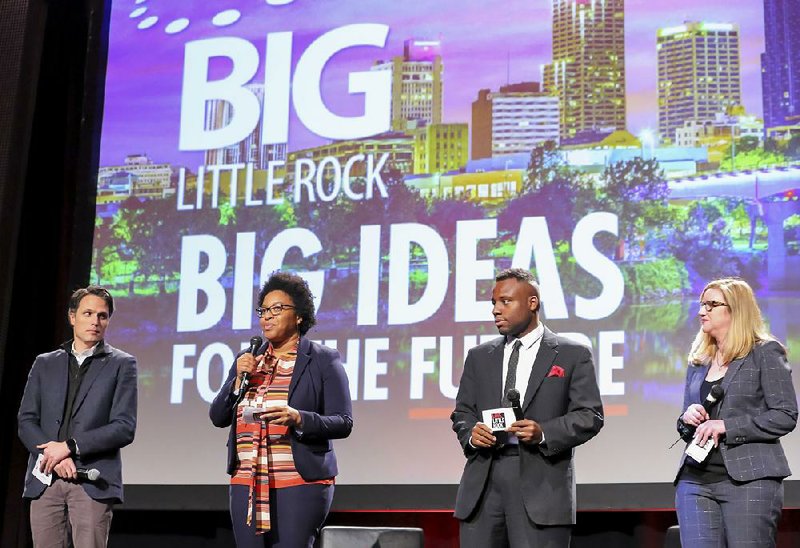 Chris East (from left), Kara Wilkins and Antwan Phillips, three of the co-chairmen of Think Big Little Rock, unveil the group’s ideas for improving the city during Thursday’s Little Rock Regional Chamber of Commerce meeting.