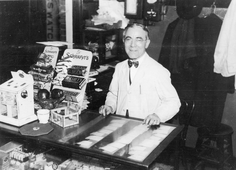 Courtesy of Shiloh Museum of Ozark History/ Frances Deane Alexander Collection (S-2012-137-557) 
George Pappas (1881-1966) stands behind cigar counter at Majestic Café — better known as George’s Majestic Lounge — at 519 W. Dickson St., Fayetteville, circa 1930, in this image by W.J. Lemke, photographer.