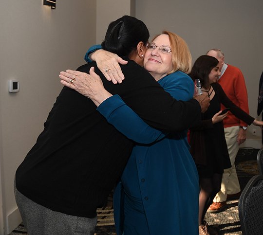 The Sentinel-Record/Mara Kuhn FAREWELL: Debbie Ugbade, left, hugs Jane Browning during the United Way of the Ouachita's annual meeting and awards banquet on Thursday at The Hotel Hot Springs & Spa. Browning is set to retire as executive director at the end of December.