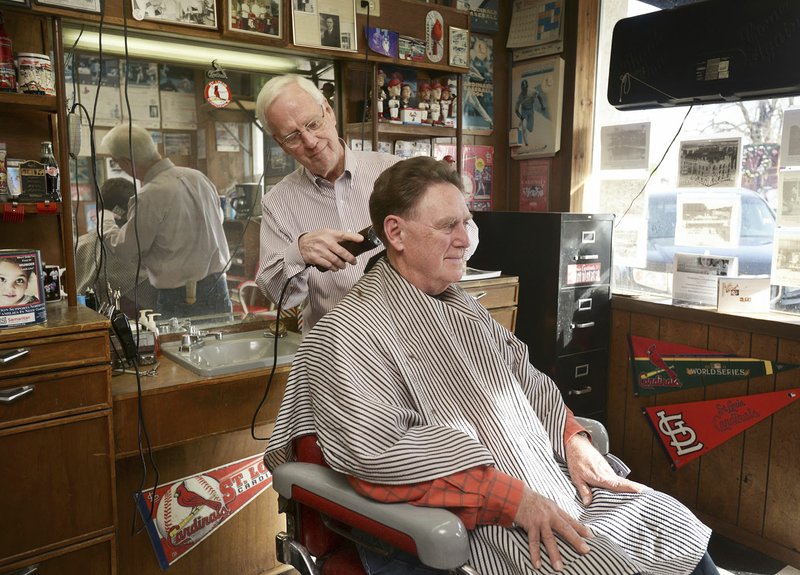 Gary Townzen gives Terry Ritchie of Bentonville a trim Dec. 15, 2016, at Townzen Barber Shop in downtown Rogers. 