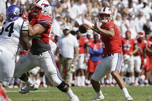 SMU quarterback Ben Hicks (8) looks to pass with a block from teammate offensive lineman Will Hopkins (60) against TCU defensive tackle Joseph Broadnax Jr. (54) during the first half an NCAA college football game in Fort Worth, Texas, Saturday, Sept. 16, 2017. (AP Photo/LM Otero)

