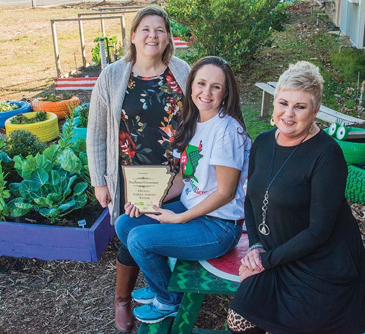 Mayflower Elementary School is the overall winner of the 2017 Arkansas Grown School Garden of the Year contest. Shown in the garden, along with the plaque the school received, are, from left, Lynn Raney, Mayflower Elementary School literary coach; Brooke-Long Lasley, a Mayflower High School graduate who spearheaded the effort to build the garden; and Candie Watts, Mayflower Elementary School principal.