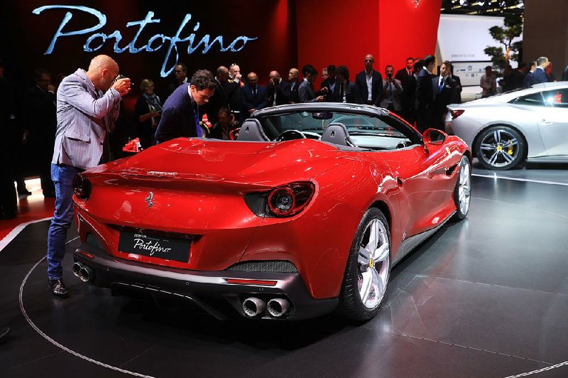 Attendees check out the interior of a Ferrari NV Portofino “entrylevel” supercar during the first media preview day of the IAA Frankfurt Motor Show in Germany in September.