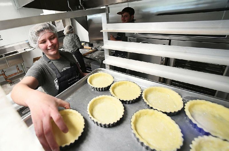 Sarah Poulton makes crusts for chocolate tarts on Wednesday at Markham & Fitz in Bentonville. 