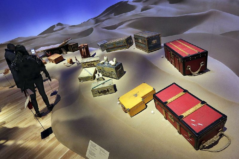 Expedition trunks, including a 1929 special photographer’s trunk (foreground right), are displayed as part of the “Volez, Voguez, Voyagez” Louis Vuitton exhibit in New York’s former American Stock Exchange building.  