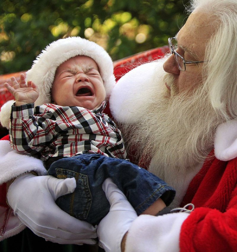 As they have for decades, parents continue to torture their small children by plopping them down in the laps of scary, hairy old geezers at the mall. This photo will come back to haunt this boy from Texas.
