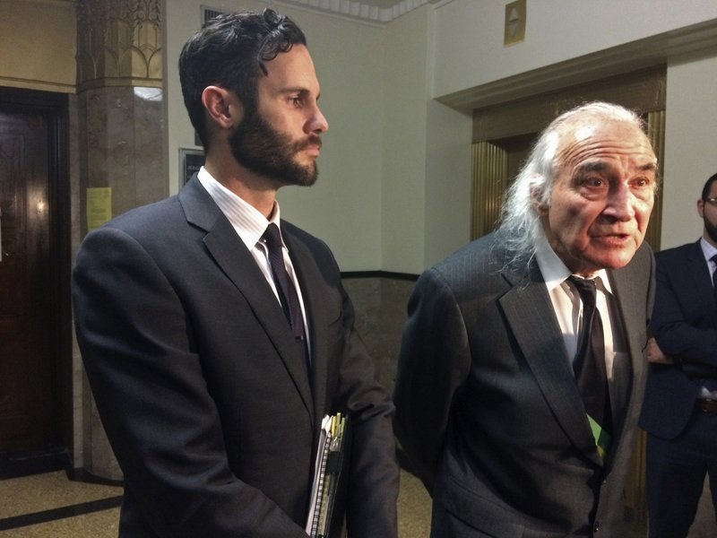 Attorneys Tyler Smith, left, and Tony Serra, right, representing defendants Max Harris and Derick Almena, who face involuntary manslaughter charges in the fire at the Oakland Ghost Ship warehouse last year, speak with reporters outside a courtroom Thursday, Dec. 14, 2017, in Oakland, Calif. A California city fire marshal said Thursday he did not find any records of requests by firefighters to inspect a warehouse where 36 people died in the worst building fire in the U.S. in more than a decade. (AP Photo/Sudhin Thanawala)