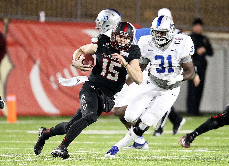 Arkansas State quarterback Justice Hansen tries to get away from Middle Tennessee State’s D.J. Sanders during the Camellia Bowl on Saturday night in Montgomery, Ala. Hansen passed for 337 yards, but he was also sacked six times.