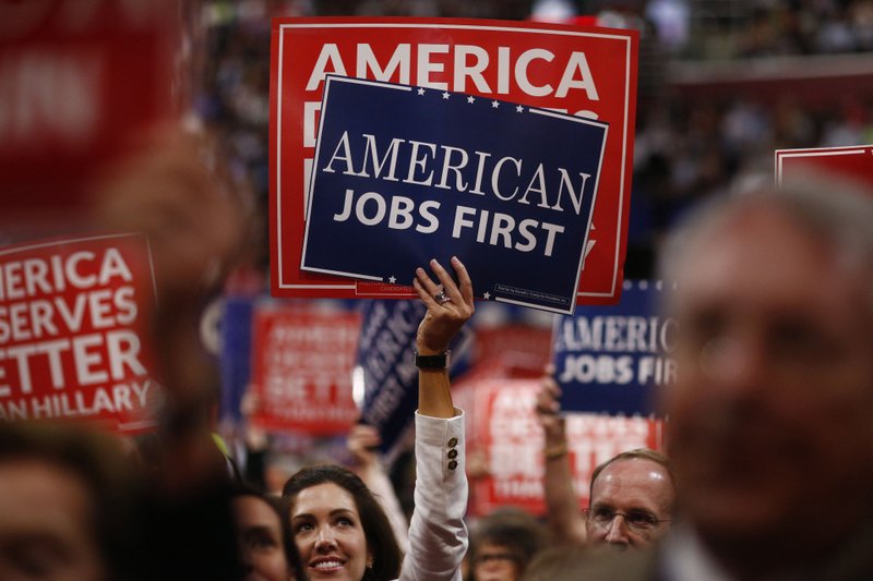 Delegates hold signs during the Republican National Convention in Cleveland on July 20, 2016. 