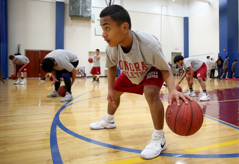 NWA Democrat-Gazette/DAVID GOTTSCHALK Davson Andres, a seventh-grade student at Sonora Middle School, participates Friday in a dribbling drill during practice with the seventh-grade team at the school. A few local school districts are engaged in discussions of starting seventh-grade athletic programs, to include an athletic period during the school day with a certified teacher coach. Springdale School District has had seventh-grade athletics since 2015.