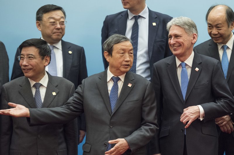 Britain's Chancellor of the Exchequer Philip Hammond, second from right, and Chinese Vice Premier Ma Kai, center, pose with delegates during the UK-China Economic Financial Dialogue at the Diaoyutai State Guesthouse in Beijing Saturday, Dec. 16, 2017. (Fred Dufour/Pool Photo via AP)