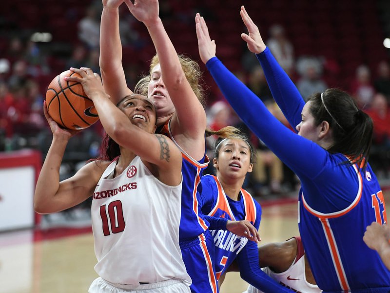 NWA Democrat-Gazette/J.T. WAMPLER Arkansas' Kiara Williams looks to shoot under pressure from UT Arlington defenders Sunday at Bud Walton Arena in Fayetteville. Arkansas won 91-57.