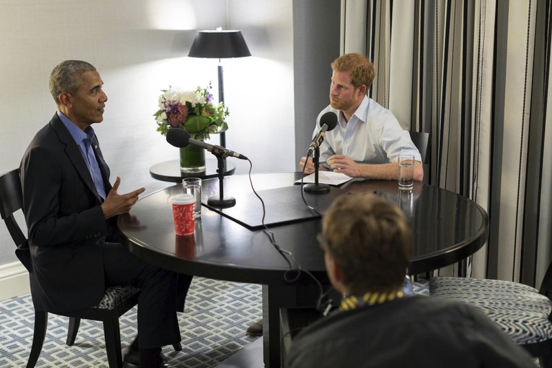 In this undated photo issued on Sunday Dec. 17, 2017 by Kensington Palace courtesy of the Obama Foundation, Britain's Prince Harry, right, interviews former US President Barack Obama as part of his guest editorship of BBC Radio 4's Today programme which is to be broadcast on the December 27, 2017. The interview was recorded in Toronto in September 2017 during the Invictus Games. 