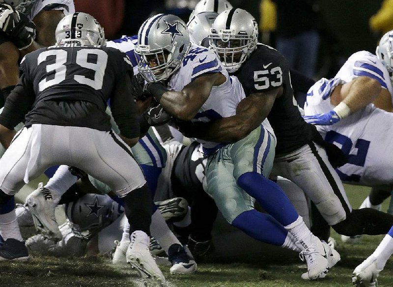 Dallas Cowboys running back Rod Smith (center) scores between Oakland Raiders linebacker NaVorro Bowman (53) and strong safety Keith McGill II (39) during the fi rst half Sunday in Oakland, Calif. The Cowboys won 20-17.