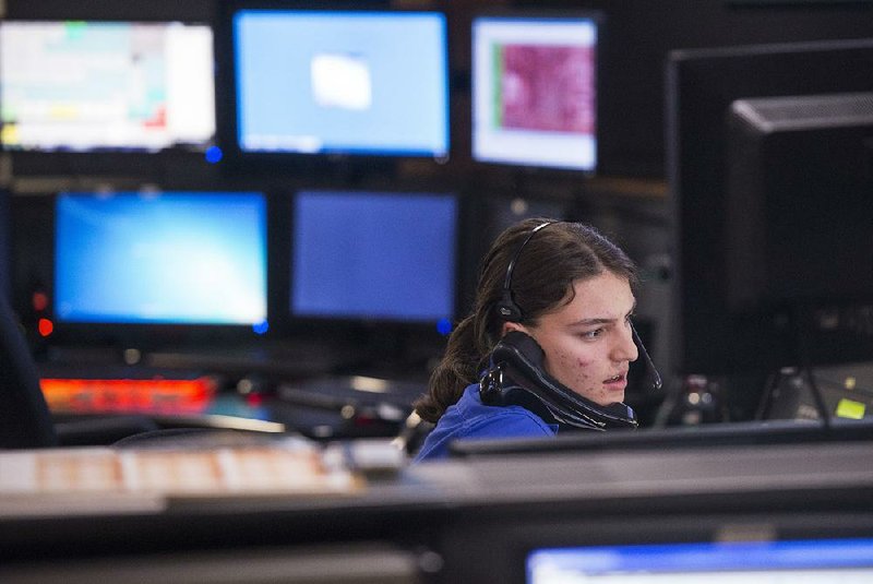 Katherine Detter takes a call this month at the 911 center in Rogers. The center, which is in the Rogers Police Department, dispatches calls for Rogers police, fire and medical services.