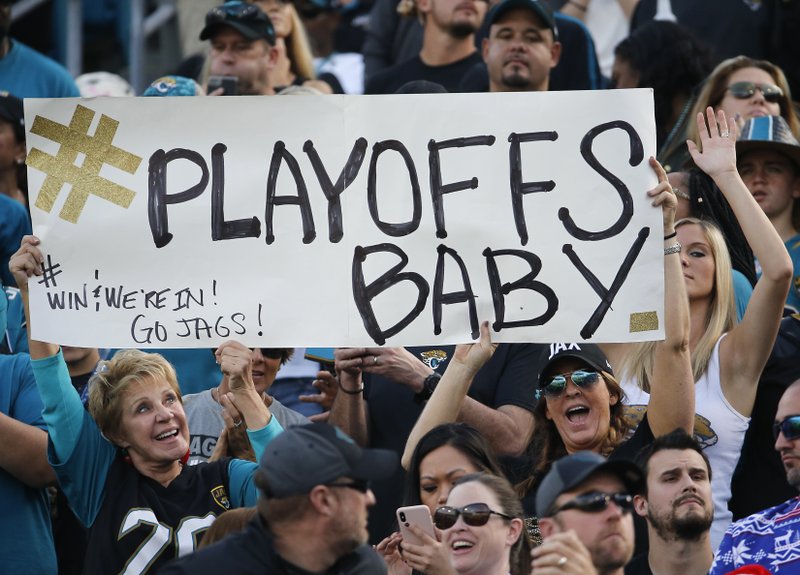 Fans hold up a sign as they cheer for the Jacksonville Jaguars during the second half of an NFL football game against the Houston Texans, Sunday, Dec. 17, 2017, in Jacksonville, Fla. 