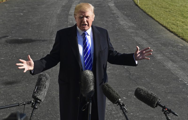 FILE - In this Dec. 16, 2017, file photo, President Donald Trump talks with reporters as he departs from the South Lawn of the White House via Marine One in Washington, to spend the weekend at Camp David in Maryland. (AP Photo/Susan Walsh, File)

