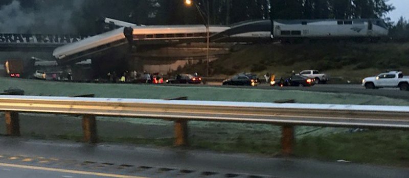 This photo provided by Danae Orlob shows an Amtrak train that derailed south of Seattle on Monday, Dec. 18, 2017. Authorities reported "injuries and casualties." The train derailed about 40 miles south of Seattle before 8 a.m., spilling at least one train car on to busy Interstate 5. (Danae Orlob via AP)	