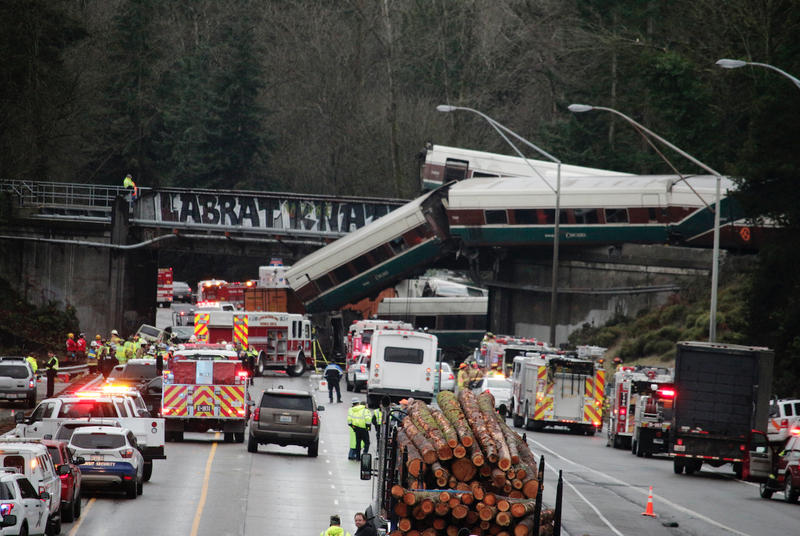 A derailed train is seen on southbound Interstate 5 on Monday, Dec. 18, 2017, in DuPont, Wash. An Amtrak train making an inaugural run on a new route derailed south of Seattle on Monday, spilling train cars onto a busy interstate in an accident that resulted in "multiple fatalities" and numerous injuries, authorities said. (AP Photo/Rachel La Corte)

