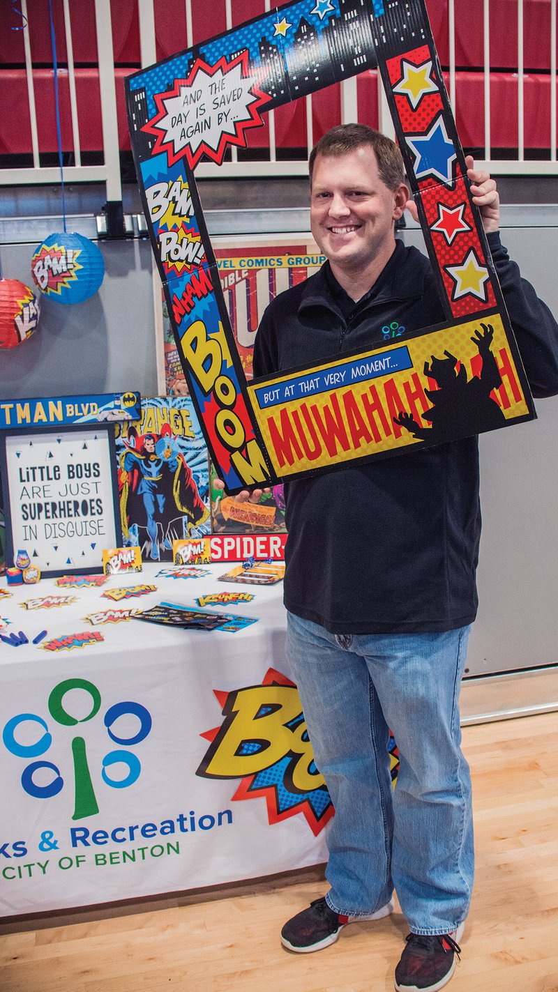 Grant Watts, special-events coordinator for Benton Parks and Recreation, holds up a comic-book-like frame that kids can have pictures made with during the upcoming second annual Mother-Son Superhero Dance on Jan. 19. The cost for the dance is $30 per couple, plus $7 for each additional child. No tickets will be sold at the door, so all tickets need to be purchased either online at apm.activecommunities.com/bentonrec or at the River Center front desk.