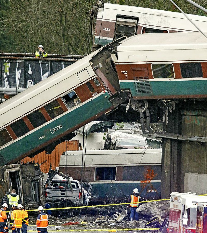 The wreckage from a derailed Amtrak train is strewn along Interstate 5 alongside smashed vehicles Monday in DuPont, Wash.