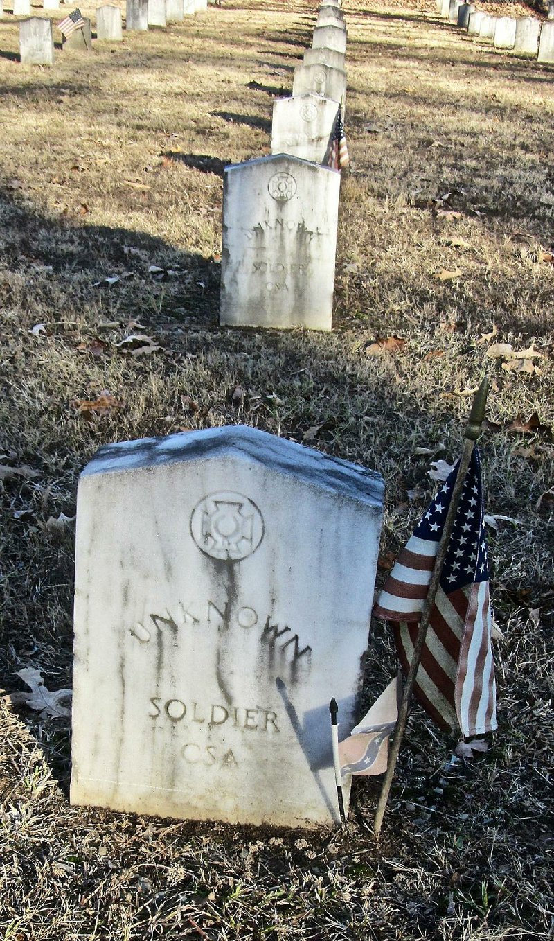 At Camp Nelson Confederate Cemetery near Cabot, a tombstone is marked by an American flag and a smaller Confederate flag.
