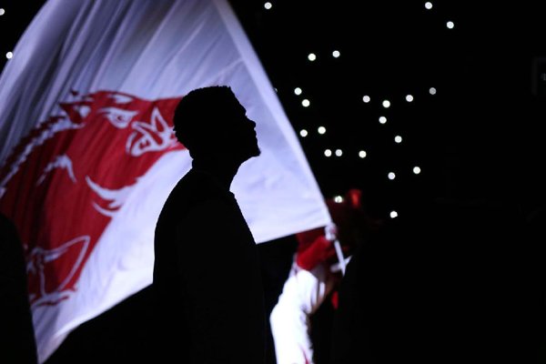 An Arkansas player stands in front of a Razorback flag during pregame introductions on Saturday, Dec. 16, 2017, in North Little Rock.