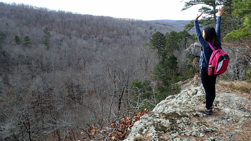 Thao Nguyen of Fayetteville marvels at the panorama Dec. 1 at Pedestal Rocks Scenic Area. Two loop trails offer four miles of hiking along stunning cliff and boulder formations, plus a 114-foot waterfall during wet times.