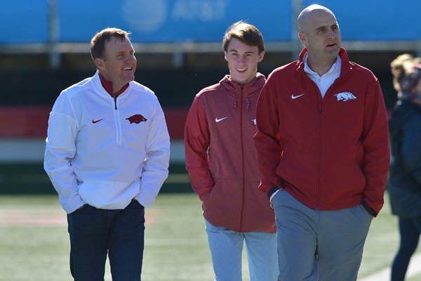 Arkansas head coach Chad Morris, left, walks with assistant coach Barry Lunney Jr., right, and son Chandler Morris, behind, prior to the Class 4A state championship game between Warren and Arkadelphia on Saturday, Dec. 9, 2017, in Little Rock. 