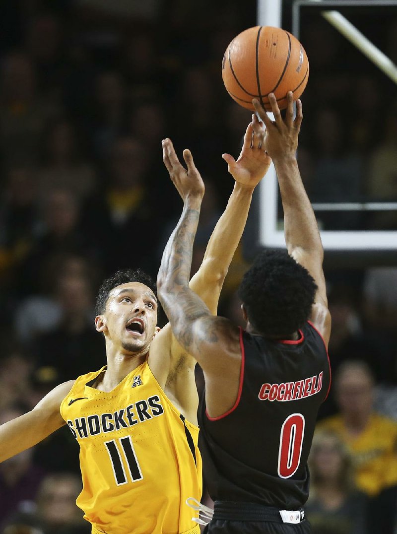 Arkansas State guard Ty Cockfield shoots over Wichita State defender Landry Shamet during the Red Wolves’ 89-80 loss to the No. 11 Shockers on Tuesday in Wichita, Kan. 
