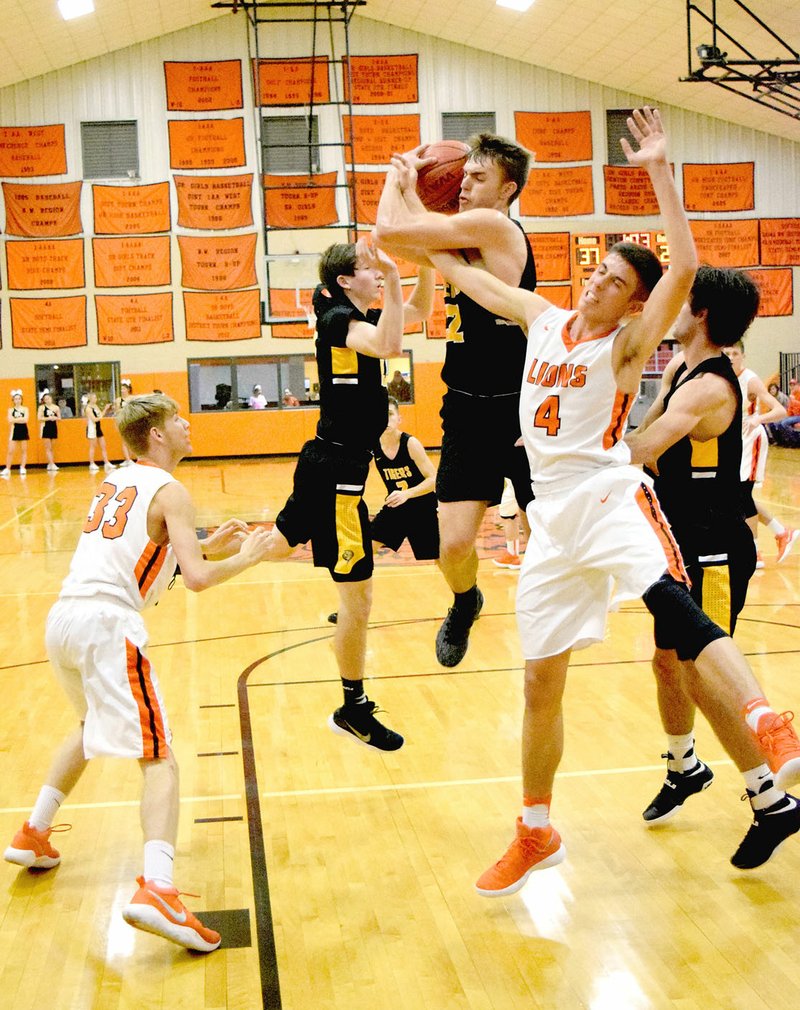 MICHAEL ECKELS NWA MEDIA Prairie Grove junior Will Pridmore battles Gravette's Dayten Wishon for a rebound. Gravette defeated Prairie Grove, 54-40, in boys basketball action on Tuesday, Dec. 12, 2017.