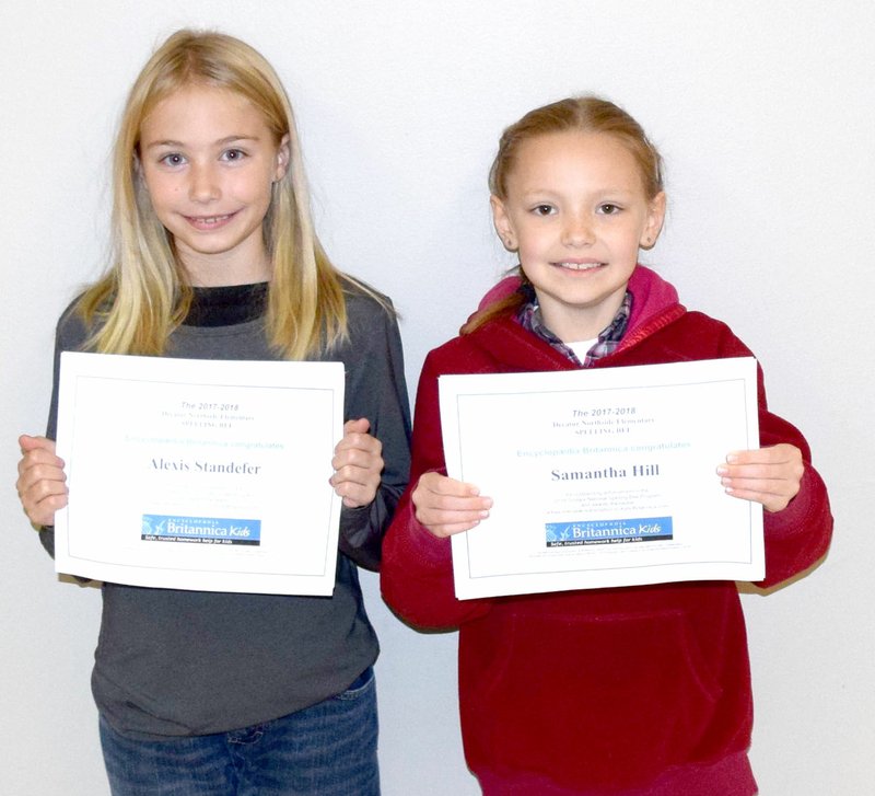 Westside Eagle Observer/MIKE ECKELS Samantha Hill (right), winner, and Alexis Standefer, runner-up, proudly show the certificates they earned during the 2017 Decatur Northside Elementary spelling bee held at the school Dec. 1.