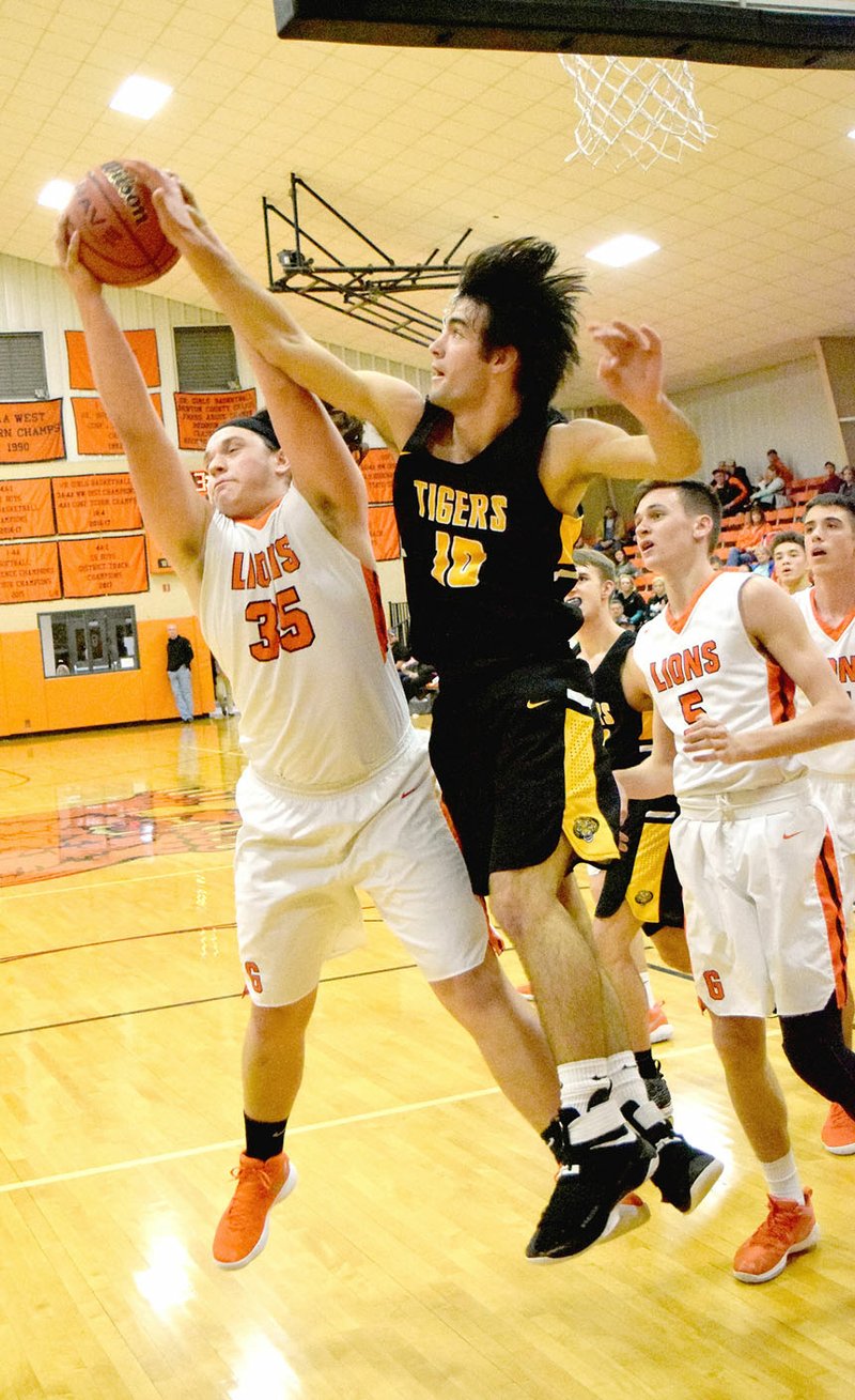 MICHAEL ECKELS EAGLE-OBSERVER/Gravette senior Bailey Soule, shown grabbing a rebound in the second half, had two quick baskets, helping the Lions jump out to an 18-5 first-quarter lead. Gravette defeated Prairie Grove, 54-40, in boys' basketball action on Tuesday, Dec. 12.