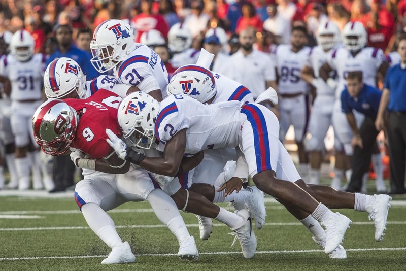 FILE - In this Sept. 16, 2017, file photo, Western Kentucky wide receiver Xavier Lane (9) is tackled by a group of Louisiana Tech players during an NCAA college football game in Bowling Green, Ky. Louisiana Tech takes on SMU in the Frisco Bowl on Dec. 20. (Austin Anthony/Daily News via AP, File)