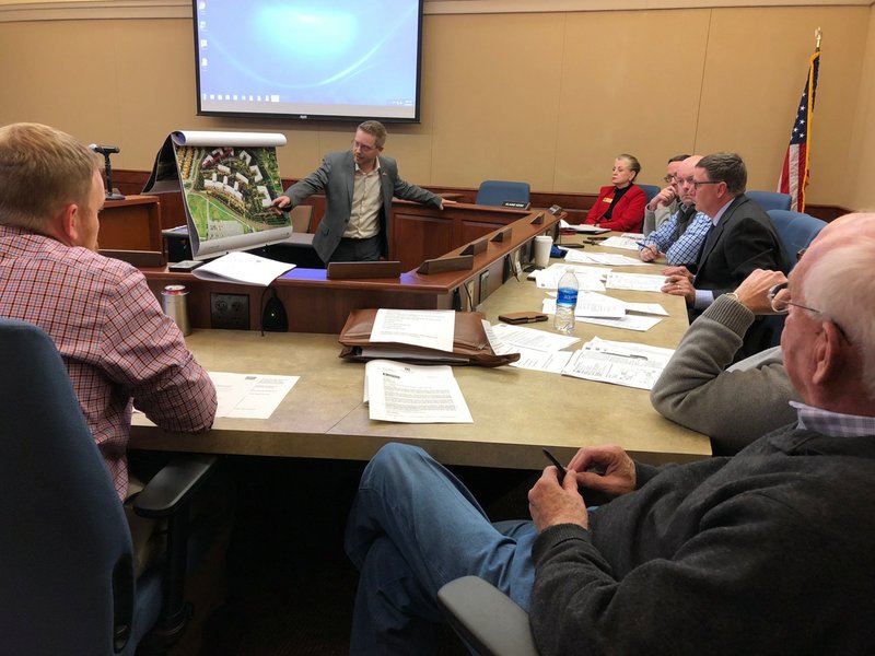 Nate Bachelor, project manager with CEI Engineering, center, presents the development plans for Crystal Flats to the Planning Commission Tuesday, Dec. 19, 2017 in the Community Development Building in Bentonville.