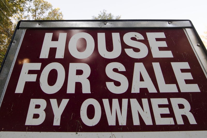 FILE - This Tuesday, Oct. 17, 2017, file photo shows a "House for Sale by Owner" sign in a yard in Fort Washington, Pa. On Wednesday, Dec. 20, 2017, the National Association of Realtors reports on sales of existing homes in November. (AP Photo/Matt Rourke, File)