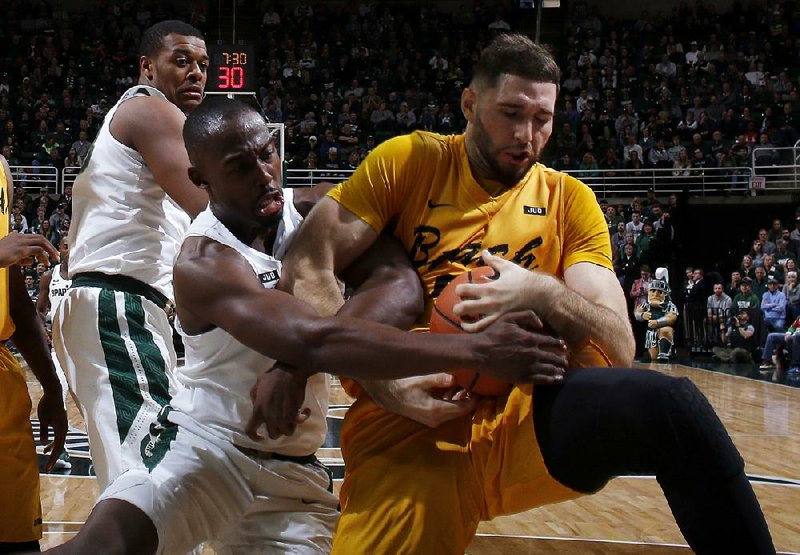 Michigan State’s Joshua Langford (left) and Long Beach State’s Gabe Levin fight for a loose ball during Thursday’s game. 