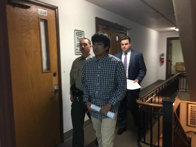 Edward Alexis Martinez-Torres (center), 22, of Springdale pleaded guilty Thursday to first-degree murder at the Benton County courthouse in Bentonville. He was charged in connection with the 2016 death of a 3-month-old boy in Bethel Heights.