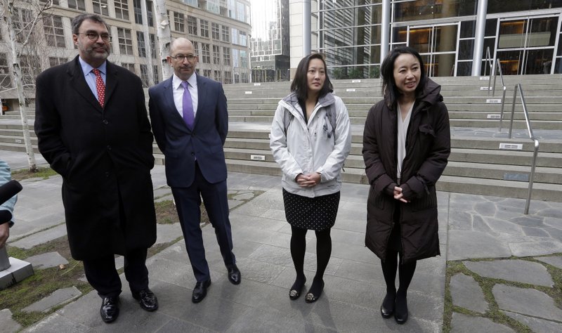 Mariko Hirose, right, a litigation director at the Urban Justice Center, Esther Sung, a staff attorney at the National Immigration Law Center, Rabbi Will Berkowitz, Jewish Family Service of Seattle CEO and Mark Hetfield, president &amp; CEO the Hebrew Immigrant Aid Society, stand in front of a federal courthouse after speaking with media members there Thursday, Dec. 21, 2017, in Seattle. Lawyers representing refugees who have legally settled in the U.S. are asking a federal judge to stop the Trump administration from keeping refugee families from entering the country. The ACLU, representing a Somali man living in Washington state, argued in federal court Thursday that Trump's indefinite ban on letting those families into the U.S. violates immigration law and the constitutional rights of the legal permanent residents. (AP Photo/Elaine Thompson)