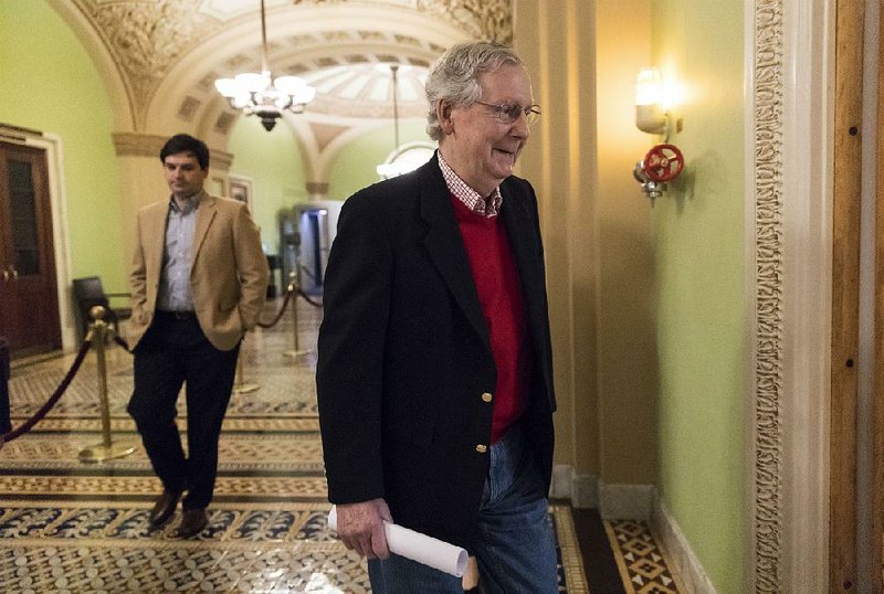 Senate Majority Leader Mitch McConnell, R-Ky., heads to a news conference Friday on Capitol Hill to discuss the GOP agenda for next year. He said he’s hoping for bipartisan cooperation.