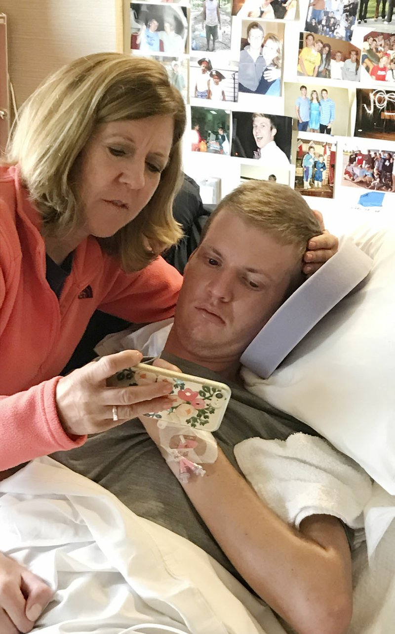 Kelly Fohner shares a phone message with her son Josh at the VA Polytrauma Rehabilitation Center at Audie L. Murphy Memorial Veterans Hospital in San Antonio, Texas in March. Josh Fohner spent several months at the center following his cycling accident before returning home in May.