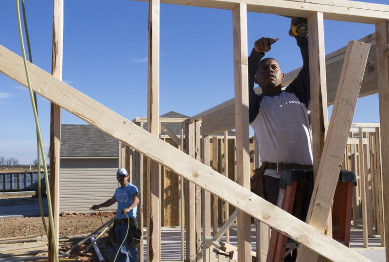 Crew members Edgar De La Cruz and Poncho Nava build a housing frame on Dec. 11 at the new Rausch Coleman development in Bentonville. Housing for Northwest Arkansans is overall more affordable than it was a decade ago, but lower-income households specifically are spending a bigger chunk of their paycheck of their housing. Developers point to the costs of labor, land and materials as obstacles to building housing that’s affordable for this group, but some are overcoming those obstacles in different ways.