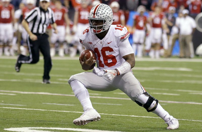 In this Dec. 2, 2017, file photo, Ohio State quarterback J.T. Barrett runs with the ball during the second half of the Big Ten championship NCAA college football game against Wisconsin in Indianapolis. 