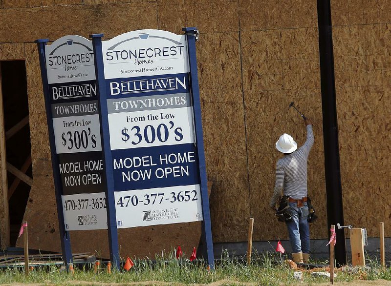 A construction worker checks panels on a town home being built in Woodstock, Ga., in the spring. House prices in October were 6.2 percent higher than last year, the Standard & Poor’s CoreLogic Case-Shiller data showed Tuesday. 