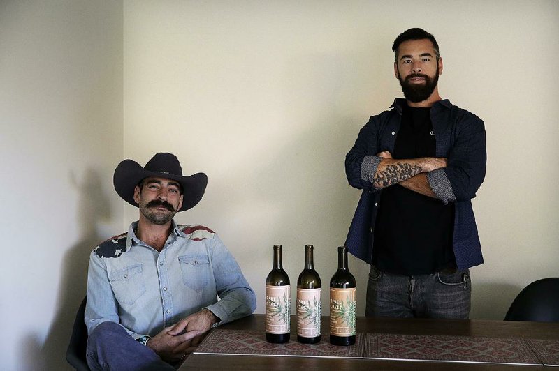 Alex Howe (right) and Chip Forsythe, co-founders of Rebel Coast Winery in Sonoma, Calif., display their cannabis-infused wine in Los Angeles. Recreational marijuana becomes legal under California law on Monday, and chefs and entrepreneurs are ready to offer marijuana infused cuisine.  
