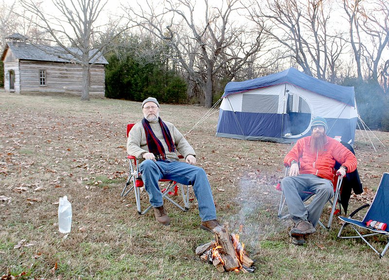 LYNN KUTTER ENTERPRISE-LEADER Bob Chisum, left, and his son, Amos Chisum, both of West Fork, participated in the first Anniversary of the Battle of Prairie Grove Campout. The park provided firewood, dinner and breakfast the next morning. About 15 people camped out on a Friday night.
